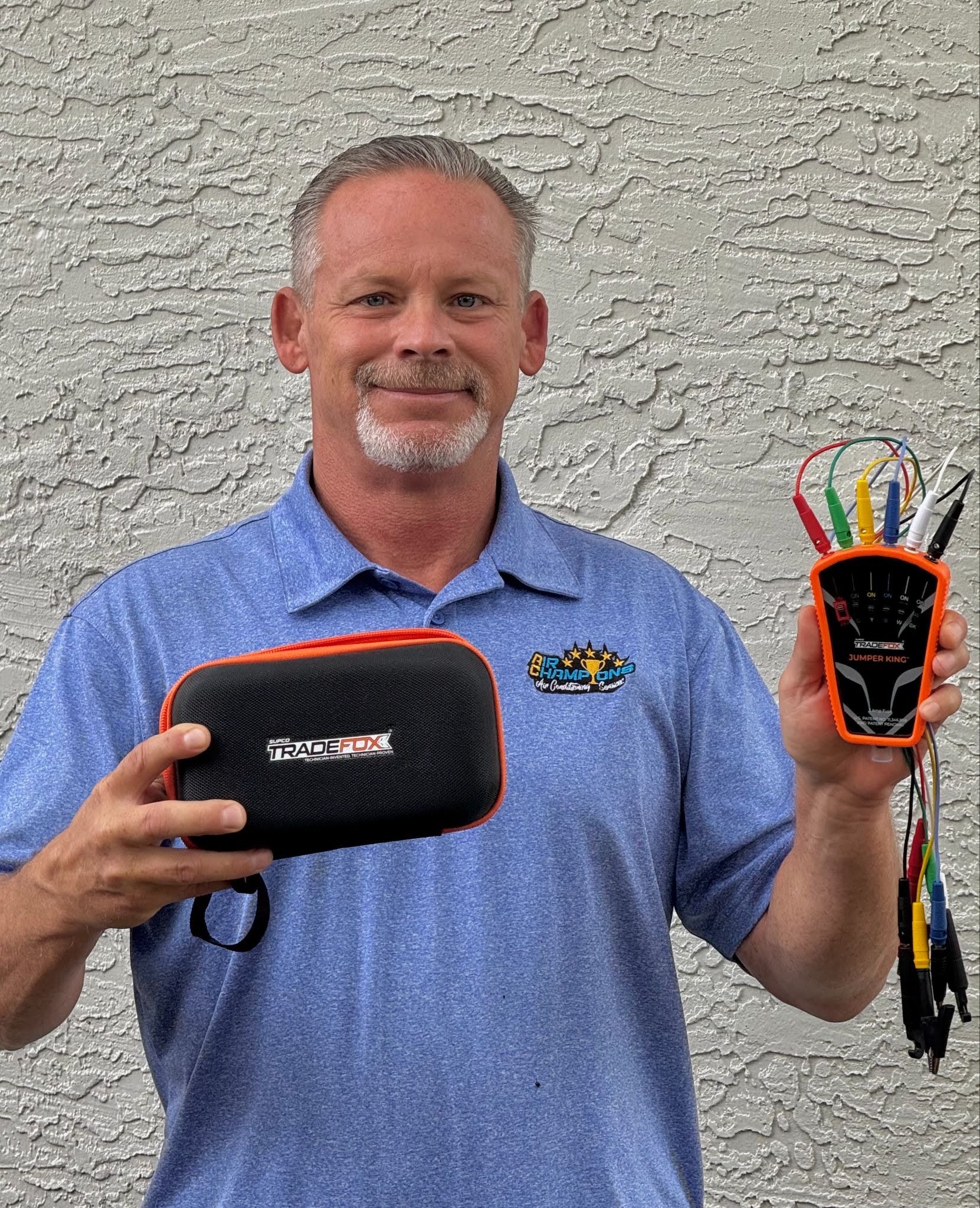Robert Kraft holding his HVAC product and carrying case